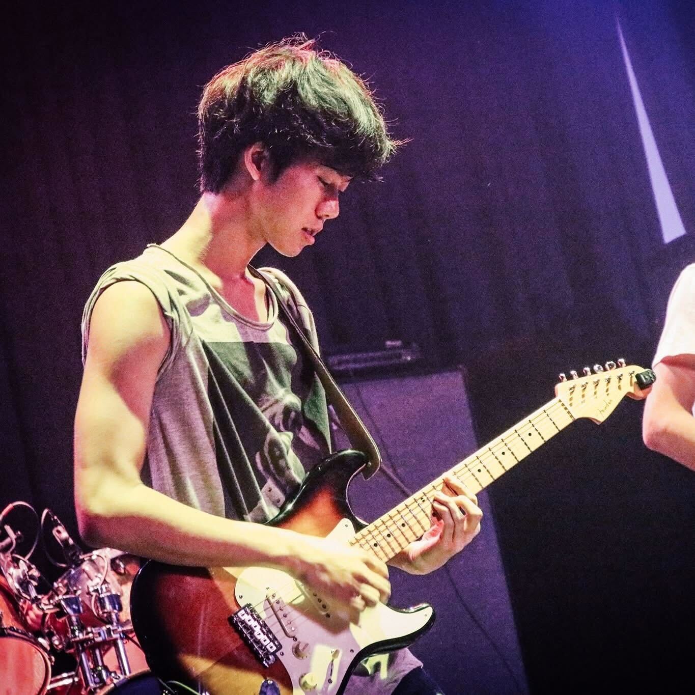 Bryan playing guitar in his college band